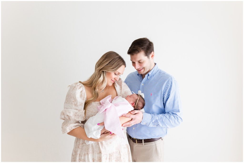 Newborn Photographer Edmond OK Family Dad and Mother holding baby girl 