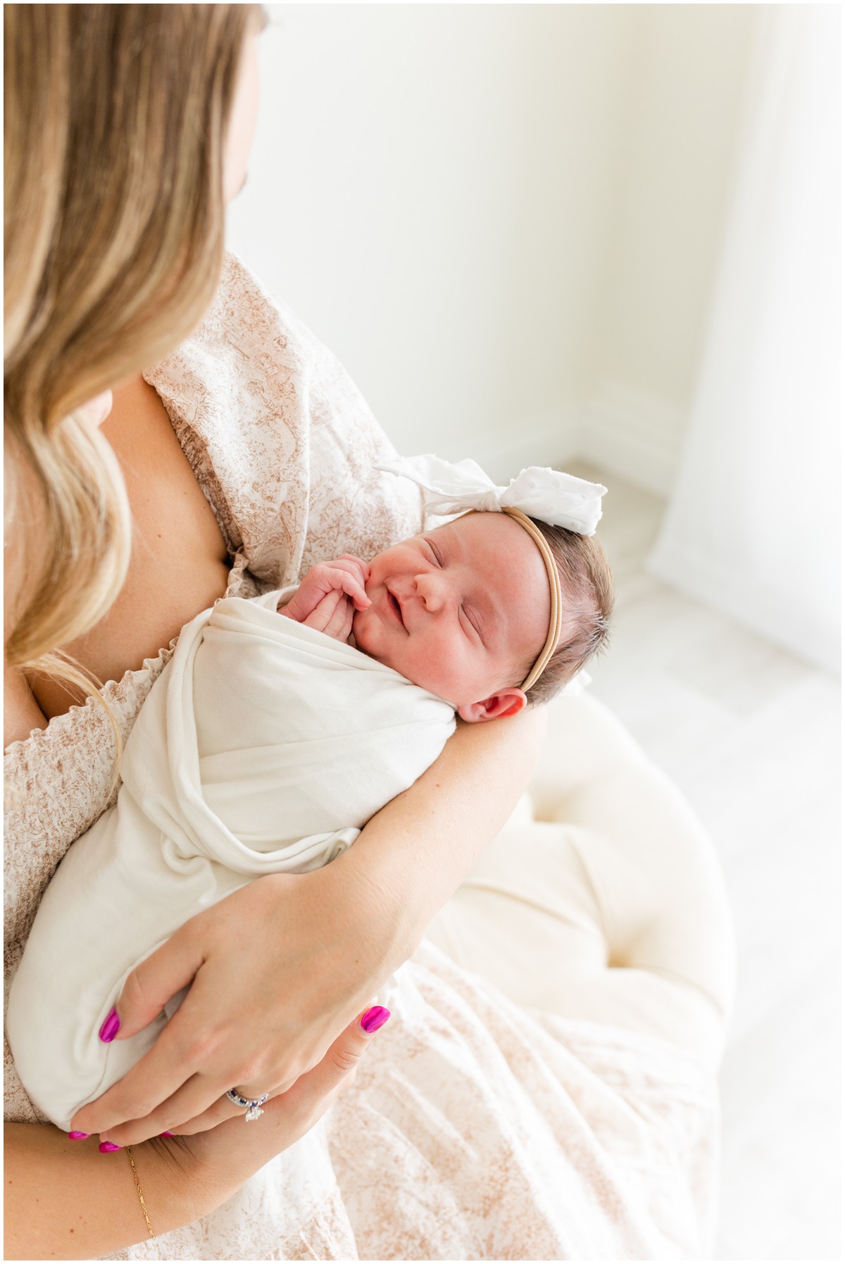 newborn-photographer-edmond-ok-mother-holding-swaddled-baby