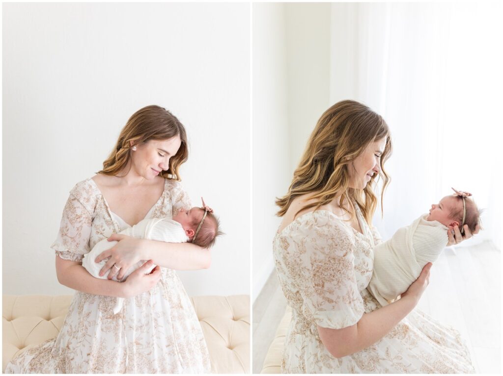 Mom sitting holding newborn baby girl swaddled 