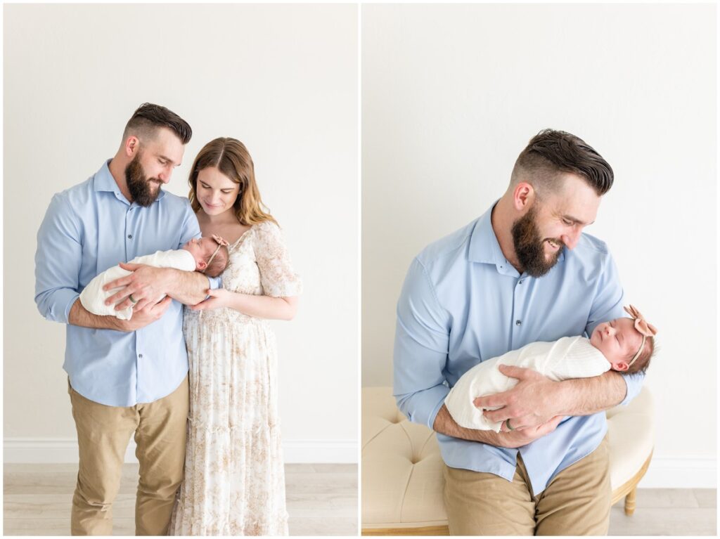 Mom and Dad holding newborn baby girl swaddled 