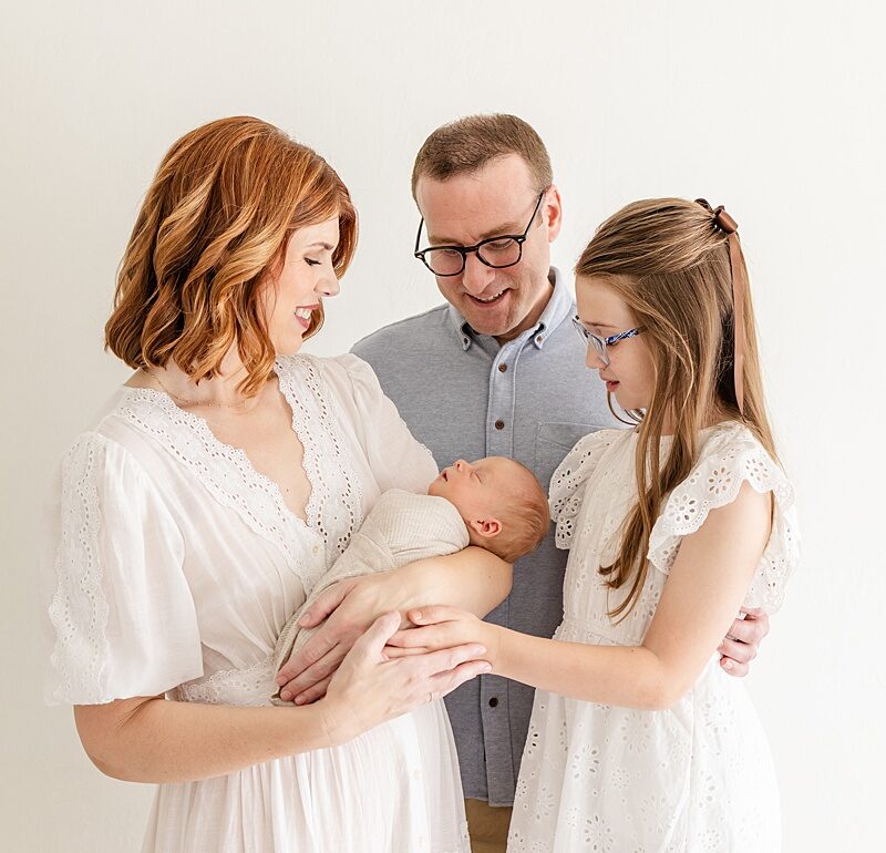 newborn swaddled with family in oklahoma city newborn photographer studio